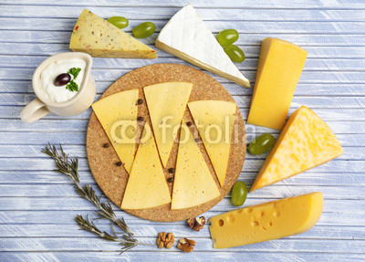 Different Italian cheese on wooden table
