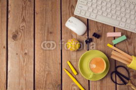 Office table background with coffee cup, pencils and computer keyboard. Business workplace or workspace concept. Top view from above with copy space