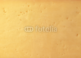 Naklejki Background of fresh yellow Swiss cheese with holes