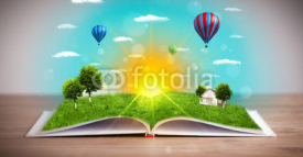 Open book with green nature world coming out of its pages