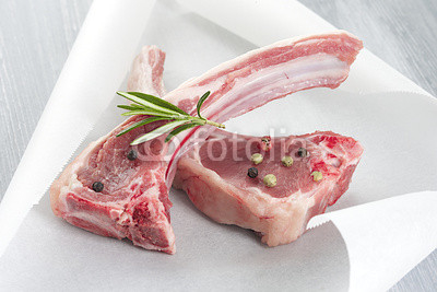 Raw fresh lamb cutlet in backing paper