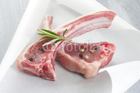 Naklejki Raw fresh lamb cutlet in backing paper