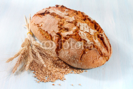 Fototapety Fresh bread with wheat on the wooden background