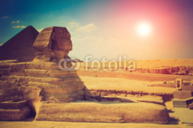 The full profile of the Great Sphinx with the pyramid in the background in Giza.