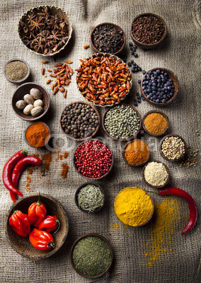 Assortment of spices in wooden bowl background 