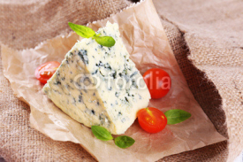 Fototapety Tasty blue cheese with tomatoes and basil, on burlap background