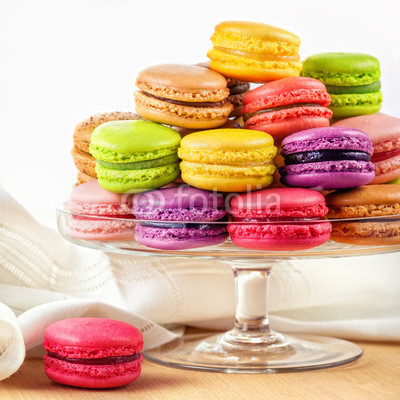 french colorful macarons in a glass cake stand