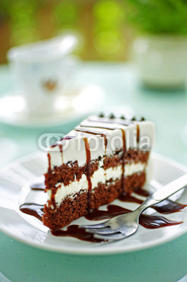 close up cake and chocolate cream in white dish