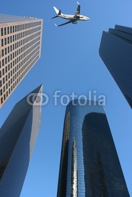 Airplane over the city, modern buildings