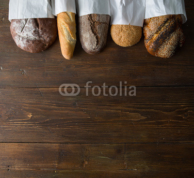 Fresh baked bread at wooden table
