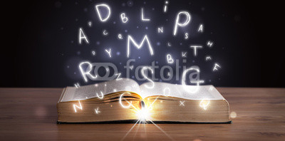 Open book with glowing letters flying out