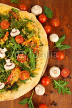 Naklejki Tasty vegetarian pizza and vegetables on wooden table