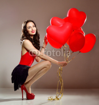 Woman with red heart balloon. Beautiful girl with bunch of heart