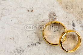 Fototapety Wedding rings on dirty canvas