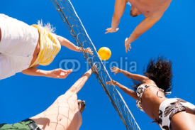 Naklejki Friends playing beach volleyball