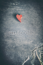 Fototapety Vintage toned wooden red heart on grunge stone background, shallow depth of field, space for text.