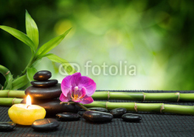 Fototapety purple orchid, candle, with stones , bamboo on black mat