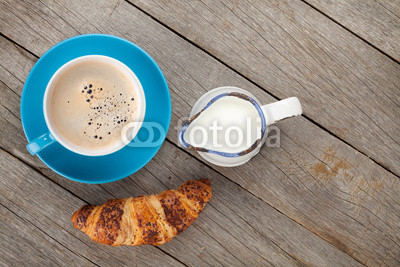 Cup of coffee, milk and fresh croissant