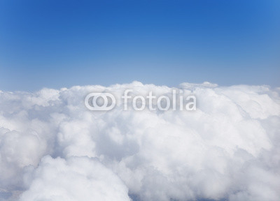 Fluffy white cumulus clouds against the sky