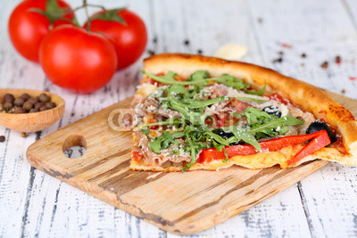 Piece of pizza with arugula