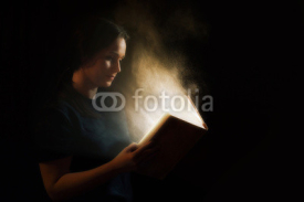 Naklejki Reading a glowing book