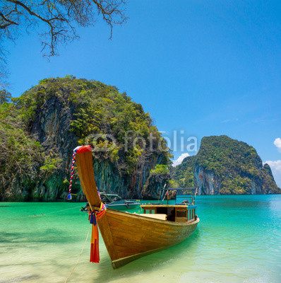 Traditional longtail boat near tropical island