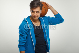 Naklejki Basketball player with ball against white background