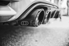 Obrazy i plakaty Double exhaust pipes of a modern sports car, black and white