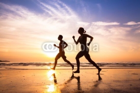 Obrazy i plakaty runners on the beach, sport and healthy lifestyle