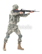 Soldier in camouflage taking aim, isolated on white
