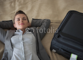 Fototapety Tired business woman relaxing in hotel room after trip