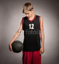 Naklejki portrait of basketball player on gray background