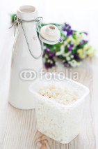 Naklejki Cottage cheese and milk bottle on the table, selective focus