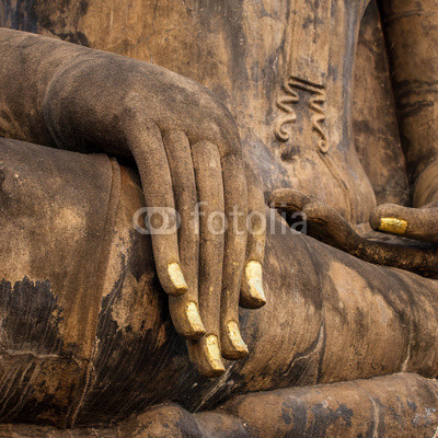 Hand of an ancient Buddha statue in the temple of Sukhothai Hist