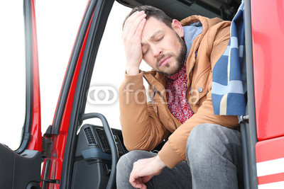 Driver in cabin of big modern truck