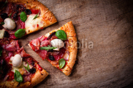 Naklejki Delicious italian pizza served on wooden table