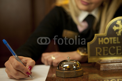 Young Woman Hotel Receptionist At The Front Desk