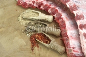 Naklejki Raw Pork Ribs Chop On The Wood Board Close-Up