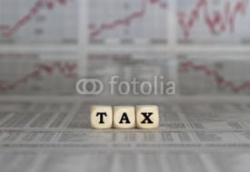 Obrazy i plakaty Tax word with calculator on newspaper background