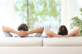 Couple relaxing on a couch at home