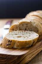 Fototapety bread with seeds on a wooden board and knife