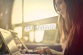 Girl working on laptop in bar 