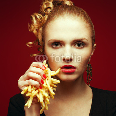 Unhealthy eating. Junk food concept. Girl with fries