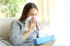 Woman blowing with flu in winter