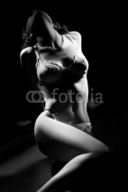 Fototapety Sexy woman body in lingerie on black.