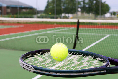 Tennis racket and ball on court