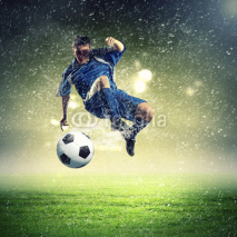 Fototapety football player striking the ball