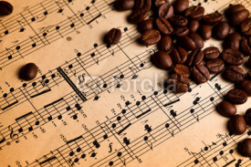 Naklejki Coffee beans on musical score