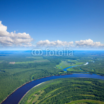 Naklejki Forest river under white clouds, top view