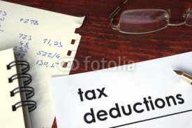 Naklejki Tax deductions written on a paper. Financial concept.